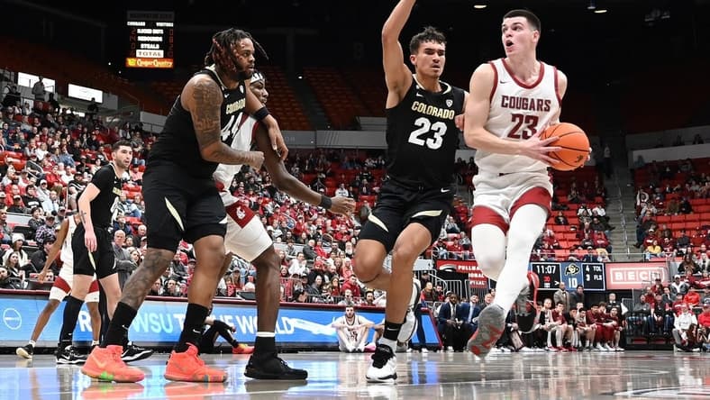 Jan 27, 2024; Pullman, Washington, USA; Washington State Cougars forward Andrej Jakimovski (right) runs the lane against Colorado Buffaloes forward Tristan da Silva (23) in the first half at Friel Court at Beasley Coliseum. Mandatory Credit: James Snook-USA TODAY Sports