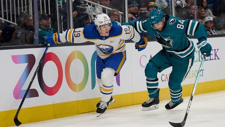 Jan 27, 2024; San Jose, California, USA; Buffalo Sabres center Peyton Krebs (19) battles for the puck against San Jose Sharks defenseman Jan Rutta (84) during the first period at SAP Center at San Jose. Mandatory Credit: Robert Edwards-USA TODAY Sports