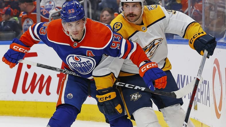 Jan 27, 2024; Edmonton, Alberta, CAN; Edmonton Oilers forward Ryan Nugent-Hopkins (93) and Nashville Predators forward Filip Forsberg (9) battle for position during the second period at Rogers Place. Mandatory Credit: Perry Nelson-USA TODAY Sports