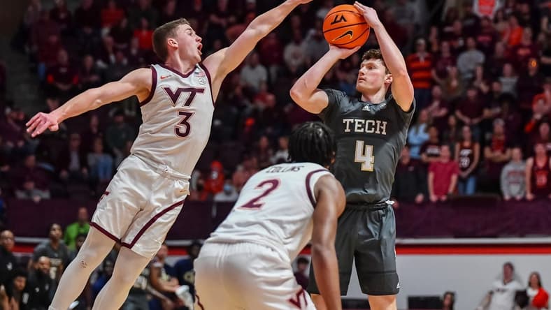 Jan 27, 2024; Blacksburg, Virginia, USA; Georgia Tech Yellow Jackets guard Carter Murphy (4) shoots while being defended by Virginia Tech Hokies guard Sean Pedulla (3) during the first half at Cassell Coliseum. Mandatory Credit: Brian Bishop-USA TODAY Sports