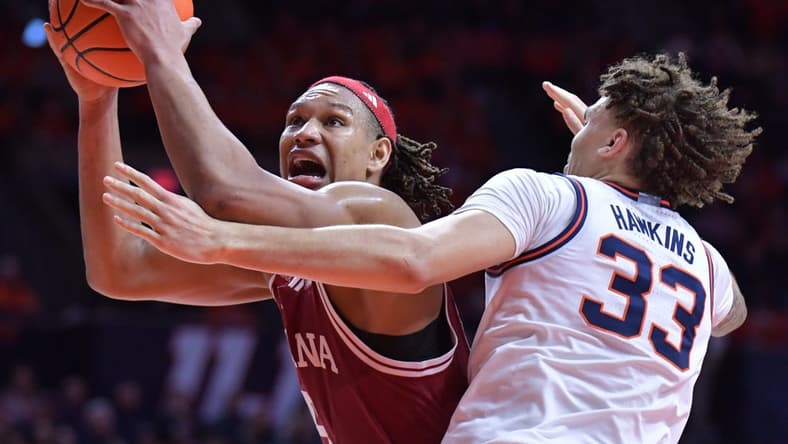 Jan 27, 2024; Champaign, Illinois, USA;  Indiana Hoosiers forward Malik Reneau (5) drives to the basket against Illinois Fighting Illini forward Coleman Hawkins (33) during the second half at State Farm Center. Mandatory Credit: Ron Johnson-USA TODAY Sports