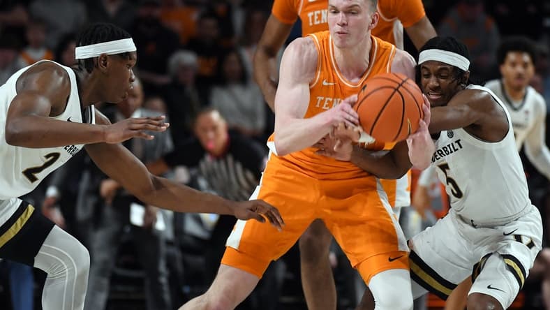 Jan 27, 2024; Nashville, Tennessee, USA; Tennessee Volunteers guard Dalton Knecht (3) is defended by Vanderbilt Commodores guard Ezra Manjon (5) and forward Ven-Allen Lubin (2) during the first half at Memorial Gymnasium. Mandatory Credit: Christopher Hanewinckel-USA TODAY Sports