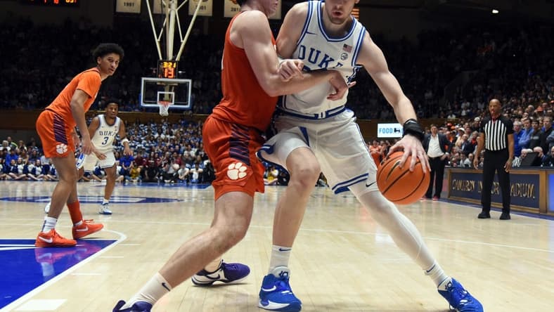 Jan 27, 2024; Durham, North Carolina, USA; Duke Blue Devils center Kyle Filipowski (30) controls the ball in front of Clemson Tigers center PJ Hall (24) during the second half at Cameron Indoor Stadium. Mandatory Credit: Rob Kinnan-USA TODAY Sports