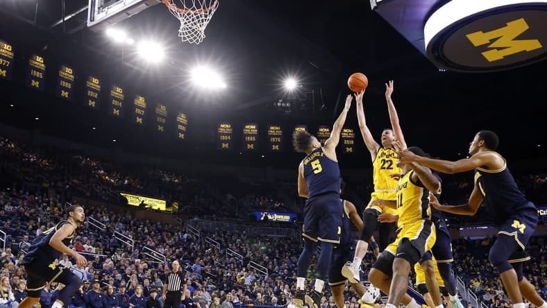 Jan 27, 2024; Ann Arbor, Michigan, USA; Iowa Hawkeyes forward Patrick McCaffery (22) shoots on Michigan Wolverines forward Terrance Williams II (5) in the second half at Crisler Center. Mandatory Credit: Rick Osentoski-USA TODAY Sports