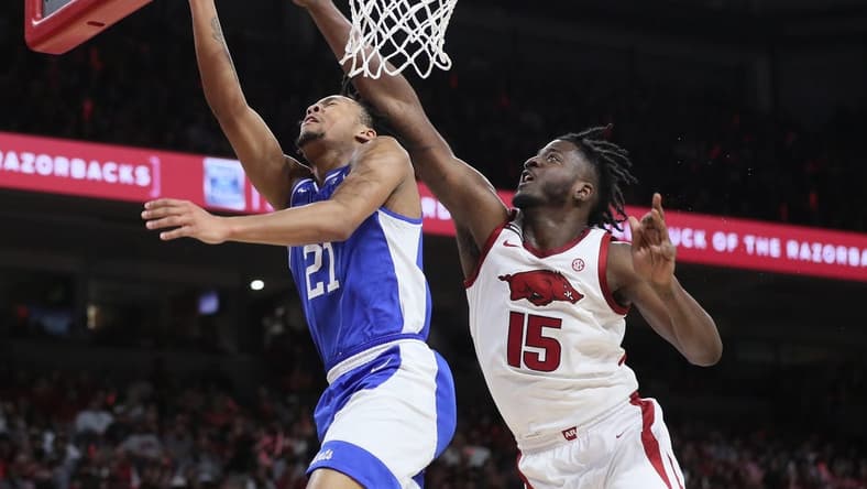 Jan 27, 2024; Fayetteville, Arkansas, USA; Kentucky Wildcats guard D.J. Wagner (21) drives to the basket during the first half as Arkansas Razorbacks forward Makhi Mitchell (15) defends at Bud Walton Arena. Mandatory Credit: Nelson Chenault-USA TODAY Sports
