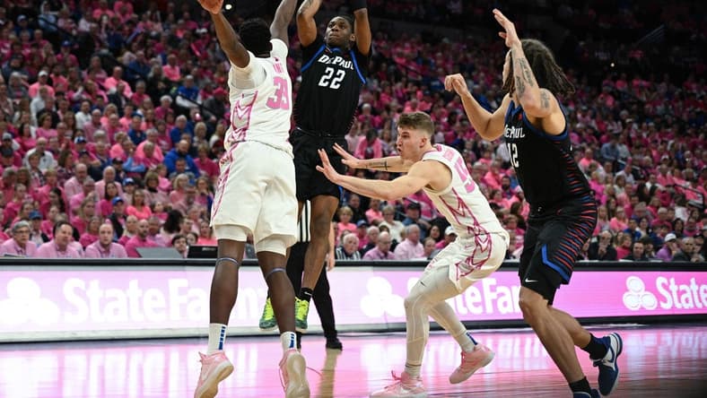 Jan 27, 2024; Omaha, Nebraska, USA; DePaul Blue Demons guard Elijah Fisher (22) attempt a shot against Creighton Bluejays center Fredrick King (33) in the first half at CHI Health Center Omaha. Mandatory Credit: Steven Branscombe-USA TODAY Sports
