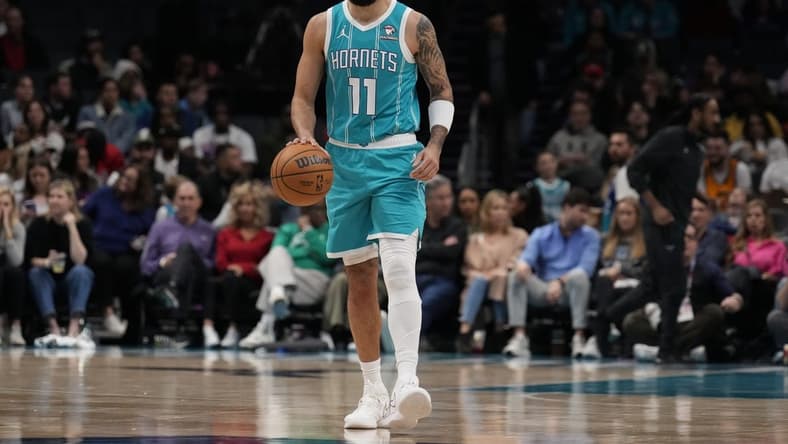 Jan 27, 2024; Charlotte, North Carolina, USA; Charlotte Hornets forward Cody Martin (11) handles the ball against the Utah Jazz during the second quarter at Spectrum Center. Mandatory Credit: Jim Dedmon-USA TODAY Sports