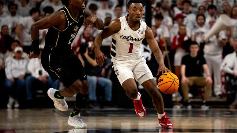 Cincinnati Bearcats guard Day Day Thomas (1) takes the ball up as UCF Knights guard Jaylin Sellers (24) guards him in the first half of the NCAA basketball game between Cincinnati Bearcats and UCF Knights at Fifth Third Arena in Cincinnati on Saturday, Jan. 27, 2024.