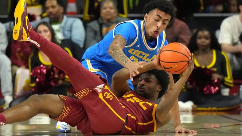 Jan 27, 2024; Los Angeles, California, USA; Southern California Trojans guard Bronny James (6) and UCLA Bruins forward Devin Williams (22) battle for the ball in the first half at Galen Center. Mandatory Credit: Kirby Lee-USA TODAY Sports