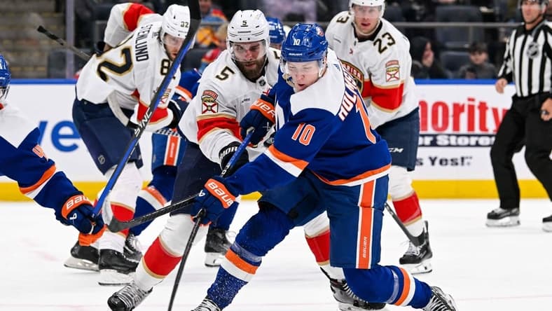 Jan 27, 2024; Elmont, New York, USA; New York Islanders right wing Simon Holmstrom (10) shoots and scores a goal against the Florida Panthers during the second period at UBS Arena. Mandatory Credit: Dennis Schneidler-USA TODAY Sports
