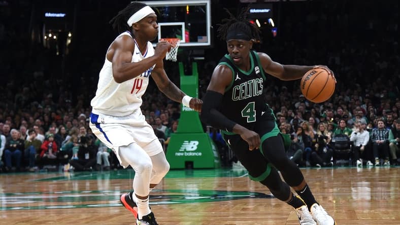 Jan 27, 2024; Boston, Massachusetts, USA; Boston Celtics guard Jrue Holiday (4) controls the ball while LA Clippers guard Terance Mann (14) defends during the second half at TD Garden. Mandatory Credit: Bob DeChiara-USA TODAY Sports