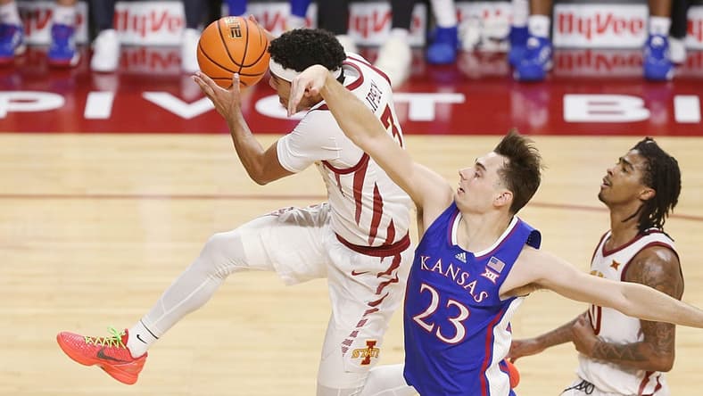 Iowa State Cyclones guard Tamin Lipsey (3) drives to the basket as Kansas Jayhawks forward Parker Braun (23) attempts to defend and founded during the first half in the Big-12 conference showdown of an NCAA college basketball at Hilton Coliseum on Saturday, Jan. 27, 2024, in Ames, Iowa.