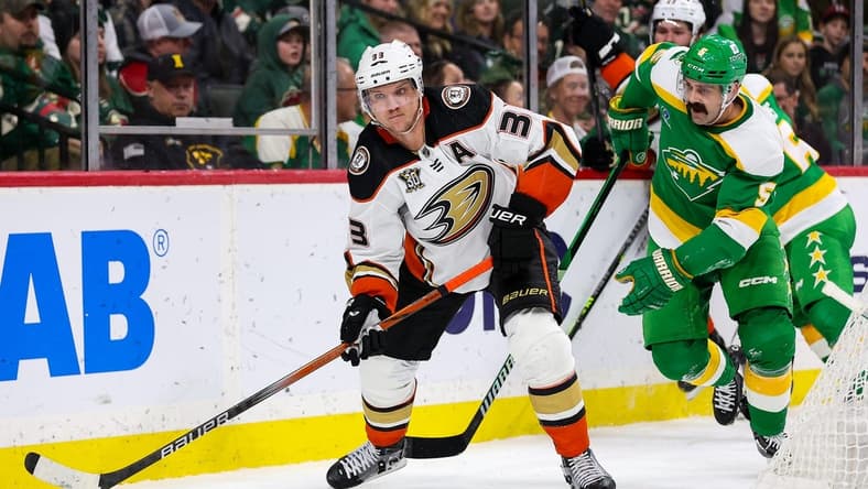 Jan 27, 2024; Saint Paul, Minnesota, USA; Anaheim Ducks right wing Jakob Silfverberg (33) passes as Minnesota Wild defenseman Jake Middleton (5) defends during the second period at Xcel Energy Center. Mandatory Credit: Matt Krohn-USA TODAY Sports