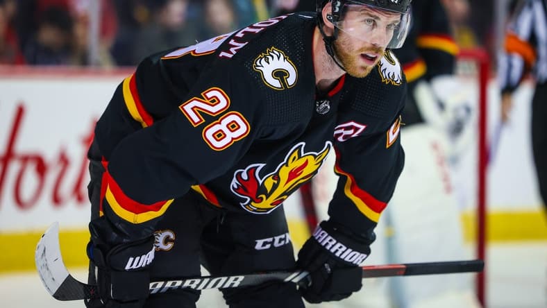 Jan 27, 2024; Calgary, Alberta, CAN; Calgary Flames center Elias Lindholm (28) during the face off against the Chicago Blackhawks during the third period at Scotiabank Saddledome. Mandatory Credit: Sergei Belski-USA TODAY Sports