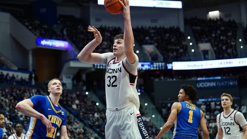 Jan 28, 2024; Hartford, Connecticut, USA; UConn Huskies center Donovan Clingan (32) makes the basket against the Xavier Musketeers in the second half at XL Center. Mandatory Credit: David Butler II-USA TODAY Sports