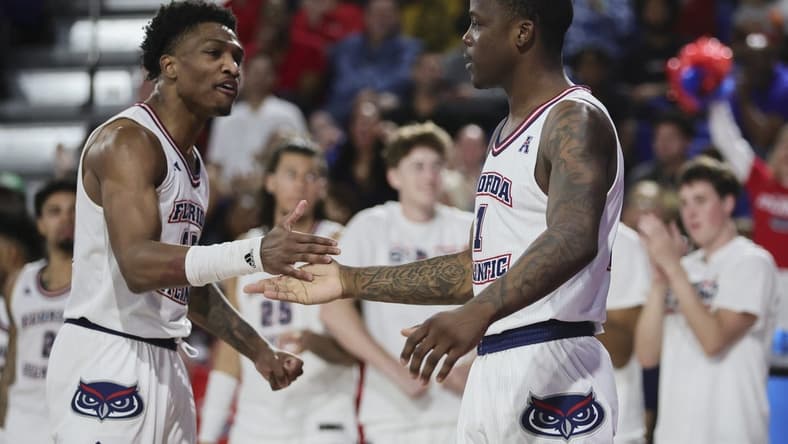 Jan 28, 2024; Boca Raton, Florida, USA; Florida Atlantic Owls guard Johnell Davis (1) celebrates with guard Brandon Weatherspoon (23) against the North Texas Mean Green during the second half at Eleanor R. Baldwin Arena. Mandatory Credit: Sam Navarro-USA TODAY Sports