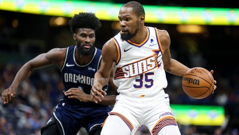 Jan 28, 2024; Orlando, Florida, USA; Phoenix Suns forward Kevin Durant (35) drives to the hoop past Orlando Magic forward Jonathan Isaac (1) in the second quarter at the Kia Center. Mandatory Credit: Nathan Ray Seebeck-USA TODAY Sports