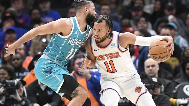 Jan 29, 2024; Charlotte, North Carolina, USA; New York Knicks guard Jalen Brunson (11) moves into Charlotte Hornets forward Cody Martin (11) during the second half at the Spectrum Center. Mandatory Credit: Sam Sharpe-USA TODAY Sports