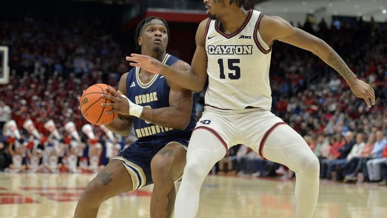 Jan 30, 2024; Dayton, Ohio, USA;  George Washington forward Darren Buchanan Jr. (3) drives against Dayton Flyers forward DaRon Holmes II (15) at University of Dayton Arena. Mandatory Credit: Matt Lunsford-USA TODAY Sports