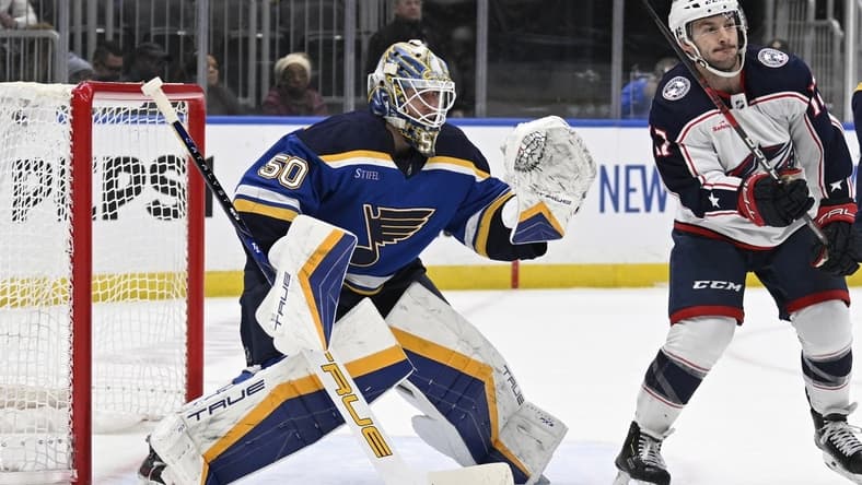 Jan 30, 2024; St. Louis, Missouri, USA; St. Louis Blues goaltender Jordan Binnington (50) defends the net from Columbus Blue Jackets right wing Justin Danforth (17) during the first period at Enterprise Center. Mandatory Credit: Jeff Le-USA TODAY Sports