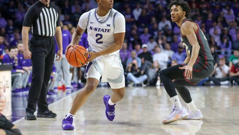 Jan 30, 2024; Manhattan, Kansas, USA; Kansas State Wildcats guard Tylor Perry (2) is guarded by Oklahoma Sooners guard Milos Uzan (12) during the first half at Bramlage Coliseum. Mandatory Credit: Scott Sewell-USA TODAY Sports