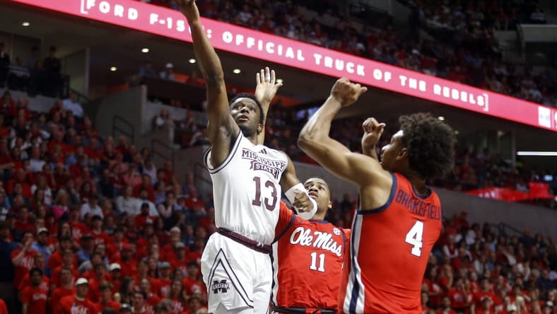 Jan 30, 2024; Oxford, Mississippi, USA; Mississippi State Bulldogs guard Josh Hubbard (13) drives to the basket as Mississippi Rebels guard Matthew Murrell (11) and forward Jaemyn Brakefield (4) defends during the first half at The Sandy and John Black Pavilion at Ole Miss. Mandatory Credit: Petre Thomas-USA TODAY Sports