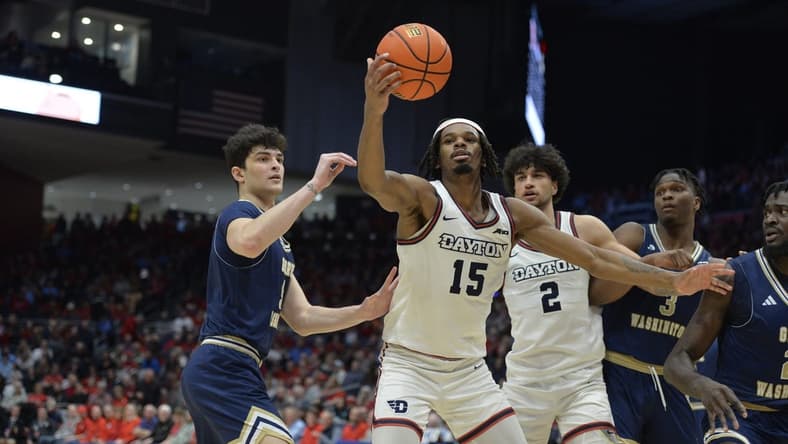 Jan 30, 2024; Dayton, Ohio, USA; Dayton Flyers forward DaRon Holmes II (15) grabs a rebound against George Washington guard Garrett Johnson (9) during the game at University of Dayton Arena. Mandatory Credit: Matt Lunsford-USA TODAY Sports
