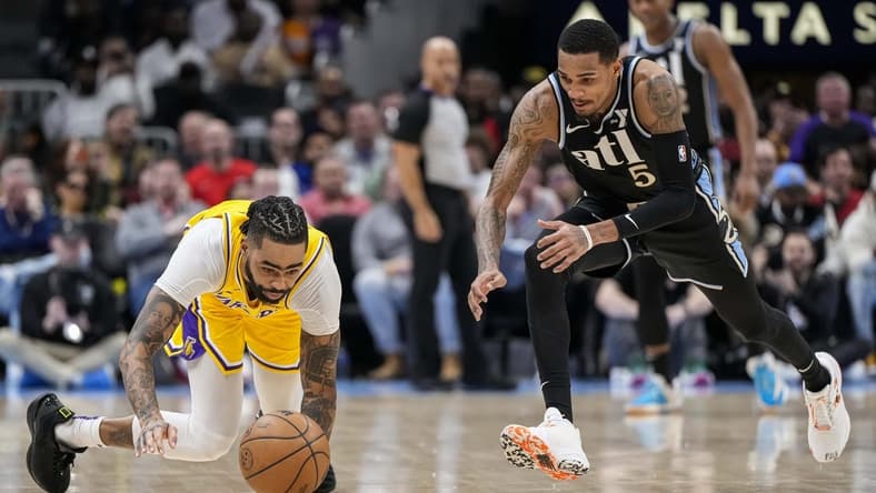Jan 30, 2024; Atlanta, Georgia, USA; Los Angeles Lakers guard D'Angelo Russell (1) loses and dives for the ball next to Atlanta Hawks guard Dejounte Murray (5) during the second half at State Farm Arena. Mandatory Credit: Dale Zanine-USA TODAY Sports