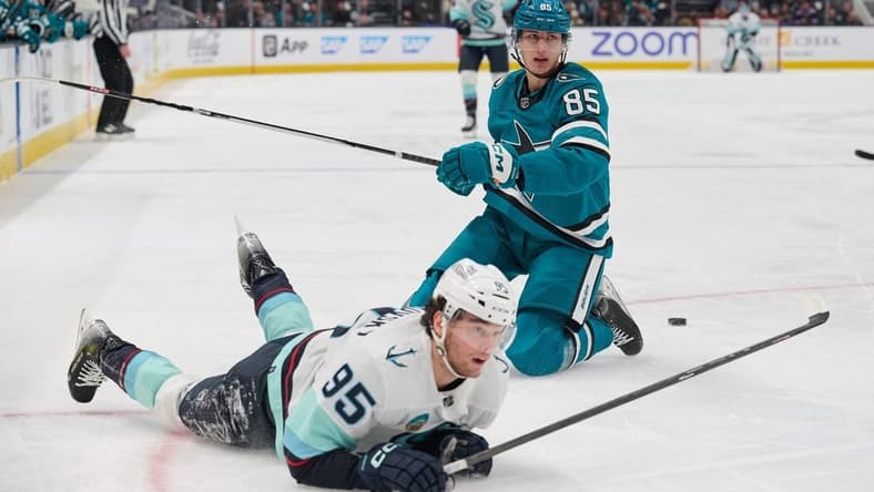 Jan 30, 2024; San Jose, California, USA; San Jose Sharks defenseman Shakir Mukhamadullin (85) and Seattle Kraken left wing Andre Burakovsky (95) after a penalty is called against Mukhamadullin during the first period at SAP Center at San Jose. Mandatory Credit: Robert Edwards-USA TODAY Sports
