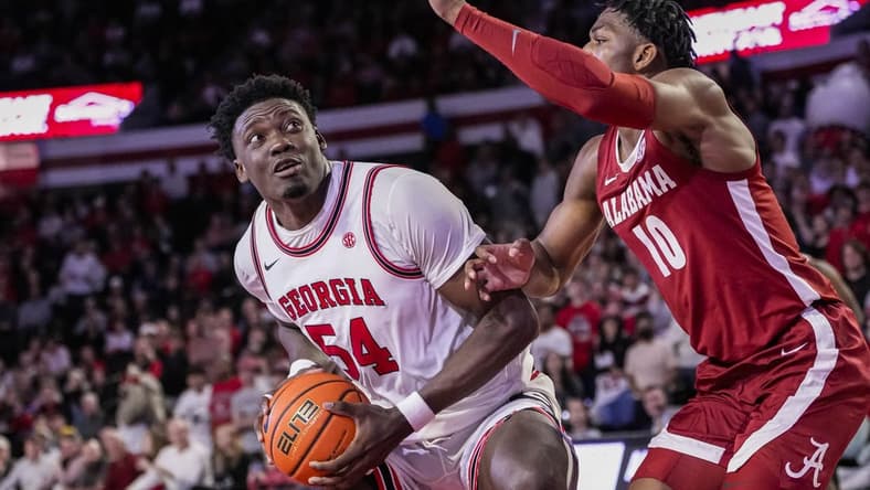 Jan 31, 2024; Athens, Georgia, USA; Georgia Bulldogs center Russel Tchewa (54) looks for a shot against Alabama Crimson Tide forward Mouhamed Dioubate (10) during the first half at Stegeman Coliseum. Mandatory Credit: Dale Zanine-USA TODAY Sports