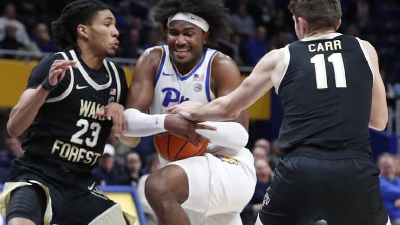 Jan 31, 2024; Pittsburgh, Pennsylvania, USA; Pittsburgh Panthers forward Blake Hinson (middle) goes to the basket against Wake Forest Demon Deacons guard Hunter Sallis (23) and forward Andrew Carr (11) during the first half at the Petersen Events Center. Mandatory Credit: Charles LeClaire-USA TODAY Sports