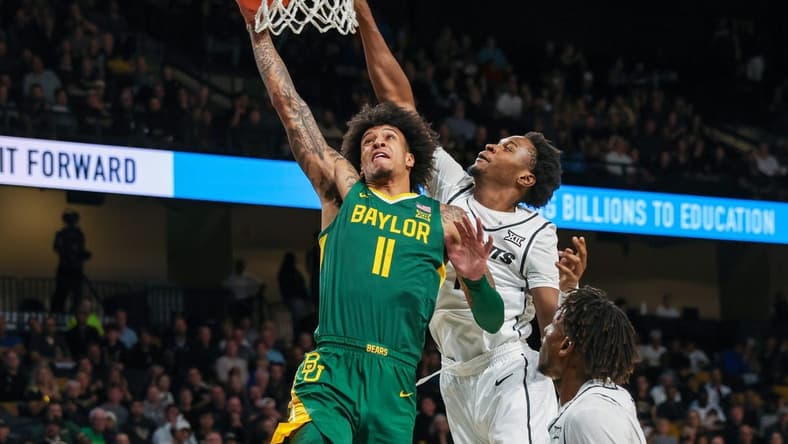 Jan 31, 2024; Orlando, Florida, USA; Baylor Bears forward Jalen Bridges (11) goes to the basket against UCF Knights forward Marchelus Avery (13) during the first half at Addition Financial Arena. Mandatory Credit: Mike Watters-USA TODAY Sports