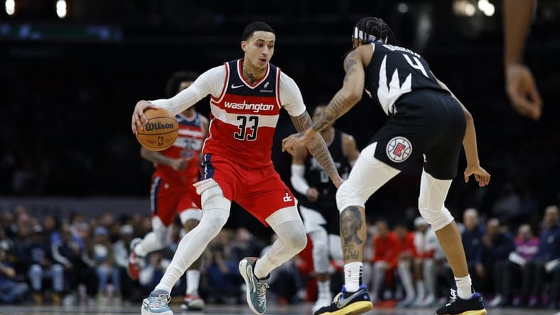 Jan 31, 2024; Washington, District of Columbia, USA; Washington Wizards forward Kyle Kuzma (33) drives to the basket as LA Clippers guard Brandon Boston Jr. (4) defends in the first half at Capital One Arena. Mandatory Credit: Geoff Burke-USA TODAY Sports