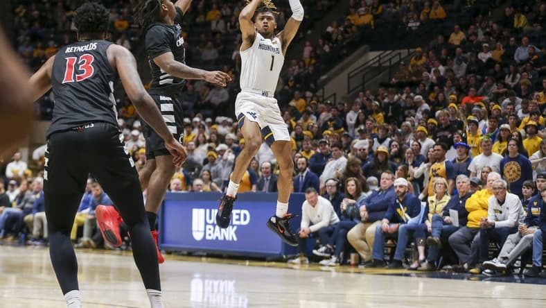 Jan 31, 2024; Morgantown, West Virginia, USA; West Virginia Mountaineers guard Noah Farrakhan (1) shoots a jumper during the second half against the Cincinnati Bearcats at WVU Coliseum. Mandatory Credit: Ben Queen-USA TODAY Sports