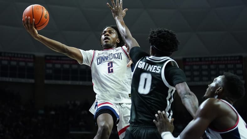 Jan 31, 2024; Storrs, Connecticut, USA; UConn Huskies guard Tristen Newton (2) shoots against Providence Friars guard Davonte Gaines (0) in the first half at Harry A. Gampel Pavilion. Mandatory Credit: David Butler II-USA TODAY Sports
