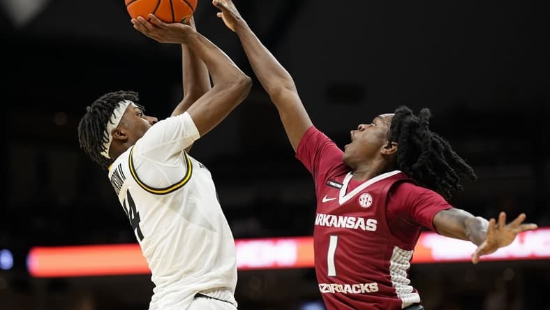 Jan 31, 2024; Columbia, Missouri, USA; Missouri Tigers guard Anthony Robinson II (14) shoots against Arkansas Razorbacks guard Keyon Menifield Jr. (1) during the first half at Mizzou Arena. Mandatory Credit: Jay Biggerstaff-USA TODAY Sports