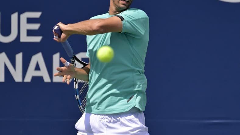 Aug 11, 2022; Montreal, QC, Canada; Albert Ramos-Vinolas (ESP) hits a forehand against against Hubert Hurkacz (POL) (not pictured) in third round play in the National Bank Open at IGA Stadium. Mandatory Credit: Eric Bolte-USA TODAY Sports