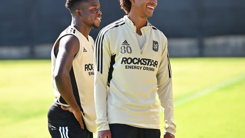 Nov 2, 2022; Los Angeles, California, US; LAFC forward Kwadwo Opokug (22) and defender Julian Gaines (80) laugh during practice at the Nectar Performance Center. Mandatory Credit: Jayne Kamin-Oncea-USA TODAY Sports