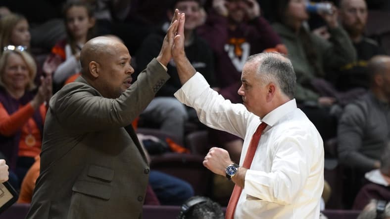 Nov 28, 2022; Blacksburg, Virginia, USA; Virginia Tech Hokies head coach Mike Young (right) high fives his assistant coach Mike Jones during the second half against the Minnesota Golden Gophers at Cassell Coliseum. Mandatory Credit: Lee Luther Jr.-USA TODAY Sports
