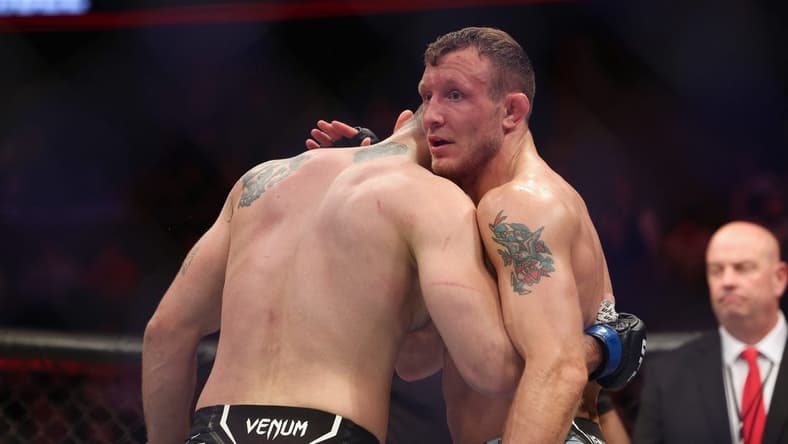 Dec 3, 2022; Orlando, Florida, USA; Jack Hermansson (red gloves) hugs Roman Dolidze (blue gloves) after the fight during UFC Fight Night at Amway Center. Mandatory Credit: Nathan Ray Seebeck-USA TODAY Sports
