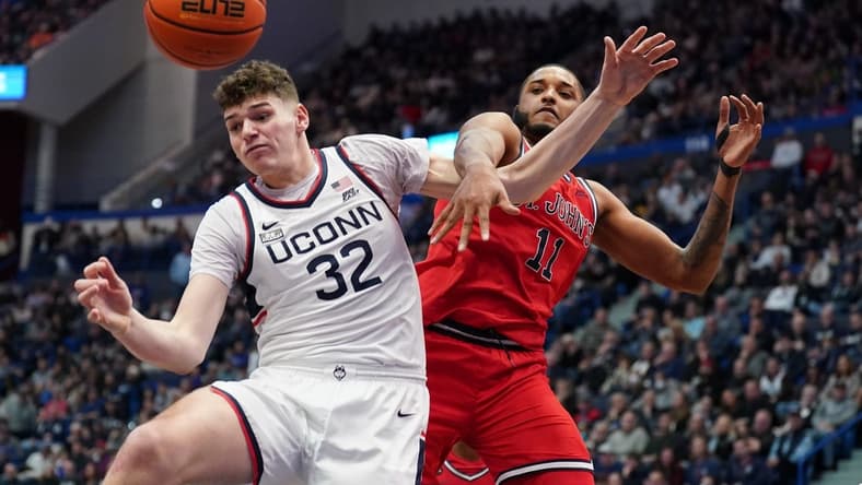 Jan 15, 2023; Hartford, Connecticut, USA; UConn Huskies center Donovan Clingan (32) and St. John's Red Storm center Joel Soriano (11) work for the ball in the second half at XL Center. Mandatory Credit: David Butler II-USA TODAY Sports