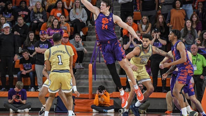 Jan 24, 2023; Clemson, South Carolina, USA; Clemson Tigers center PJ Hall (24) defends against Georgia Tech Yellow Jackets guard Kyle Sturdivant (1) during the second half at Littlejohn Coliseum. Mandatory Credit: Ken Ruinard-USA TODAY Sports