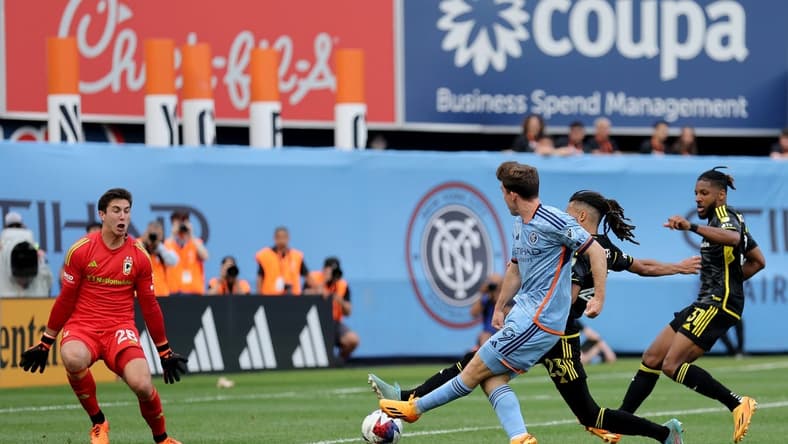 Jun 17, 2023; New York, New York, USA; New York City FC forward Gabriel Segal (19) scores a goal against Columbus Crew SC goalkeeper Patrick Schulte (28) and defenders Mohamed Farsi (23) and Steven Moreira (31) during the second half at Yankee Stadium. Mandatory Credit: Brad Penner-USA TODAY Sports