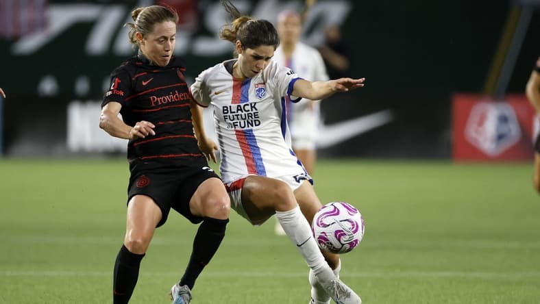 Jun 28, 2023; Portland, OR, USA; OL Reign forward McKenzie Weinert (51) kicks the ball past the Portland Throws FC during the second half at Providence Park. Mandatory Credit: Soobum Im-USA TODAY Sports