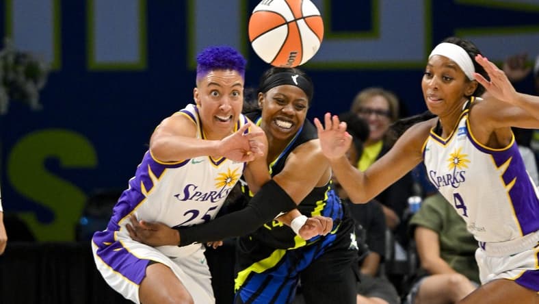 Jul 22, 2023; Arlington, Texas, USA; Los Angeles Sparks guard Layshia Clarendon (25) and guard Lexie Brown (4) and Dallas Wings guard Arike Ogunbowale (24) battle for the loose ball during the second half at College Park Center. Mandatory Credit: Jerome Miron-USA TODAY Sports