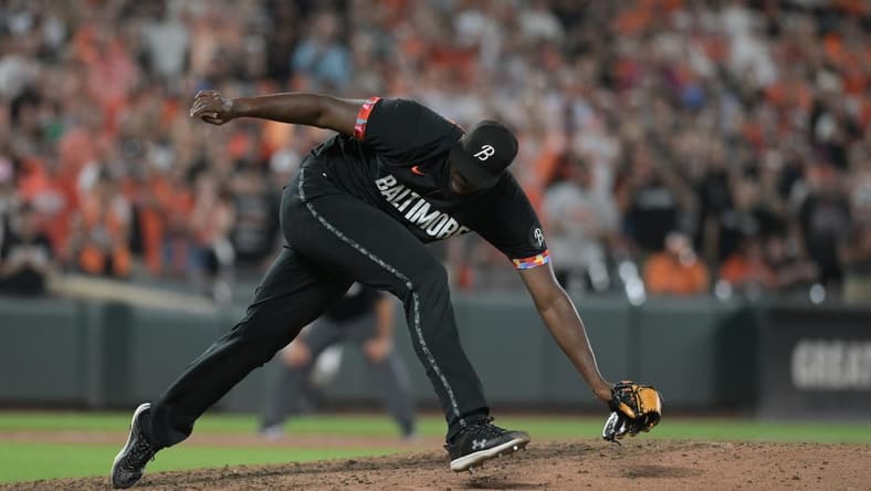 Aug 25, 2023; Baltimore, Maryland, USA; Baltimore Orioles relief pitcher Felix Bautista (74) slips while throwing a ninth inning pitch against the Colorado Rockies  at Oriole Park at Camden Yards. Mandatory Credit: Tommy Gilligan-USA TODAY Sports