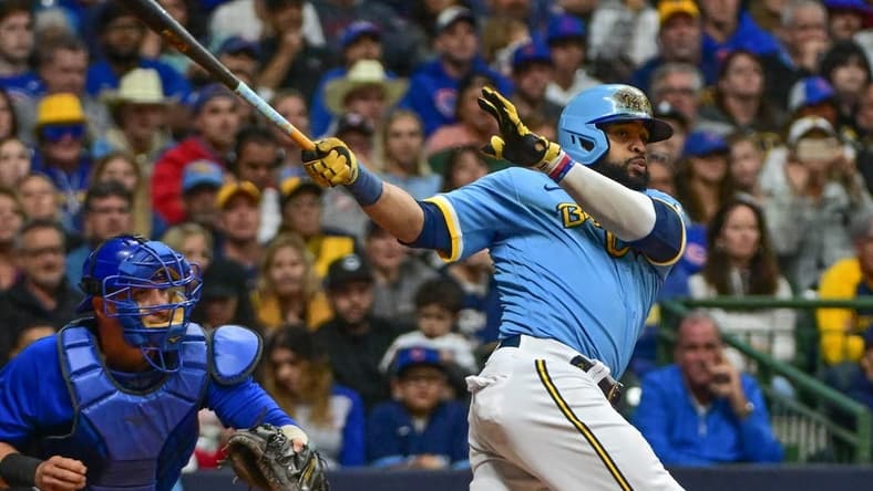 Sep 29, 2023; Milwaukee, Wisconsin, USA; Milwaukee Brewers first baseman Carlos Santana (41) hits a RBI triple against the Chicago Cubs in the fifth inning at American Family Field. Mandatory Credit: Benny Sieu-USA TODAY Sports