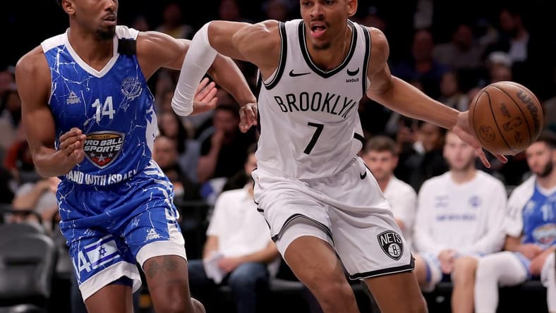 Oct 12, 2023; Brooklyn, NY, USA; Brooklyn Nets forward Darius Bazley (7) drives to the basket against Maccabi Ra'anana guard Dakarai Tucker (14) during the fourth quarter at Barclays Center. Mandatory Credit: Brad Penner-USA TODAY Sports