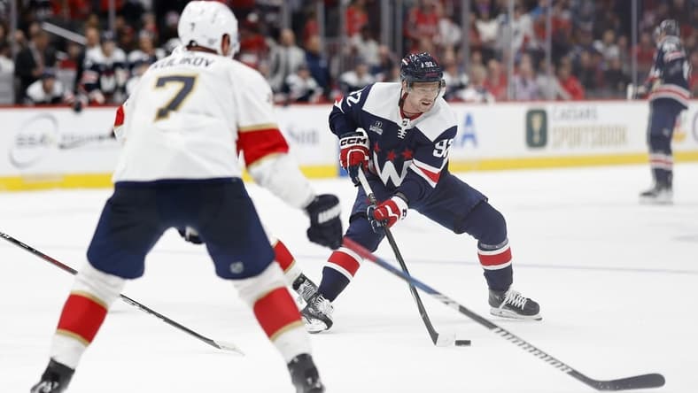 Nov 8, 2023; Washington, District of Columbia, USA;Washington Capitals center Evgeny Kuznetsov (92) skates with the puck as Florida Panthers defenseman Dmitry Kulikov (7) defends in the third period at Capital One Arena. Mandatory Credit: Geoff Burke-USA TODAY Sports