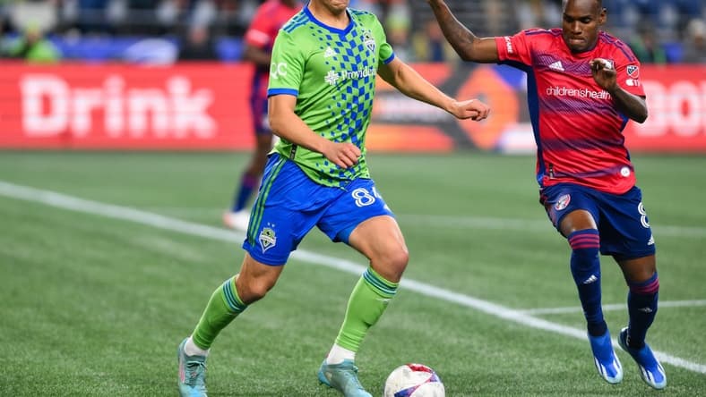 Nov 10, 2023; Seattle, Washington, USA; Seattle Sounders midfielder Josh Atencio (84) dribbles the ball as FC Dallas forward J der Obrian (8) defends during the first half at Lumen Field. Mandatory Credit: Steven Bisig-USA TODAY Sports